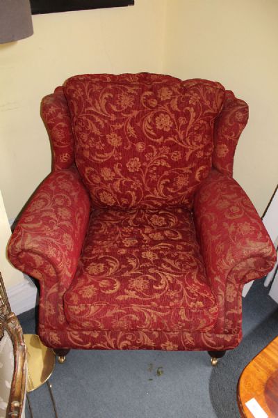 A RED UPHOLSTERED ARMCHAIR at deVeres Auctions