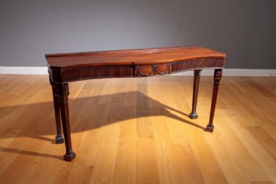 A GEORGIAN REVIVAL MAHOGANY SERPENTINE FRONTED SERVING TABLE at deVeres Auctions