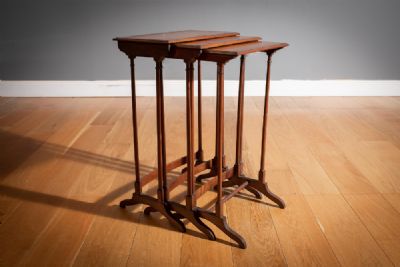 A MAHOGANY, ROSEWOOD CROSSBANDED AND SATINWOOD AND EBONY INLAID NEST OF THREE TABLES at deVeres Auctions