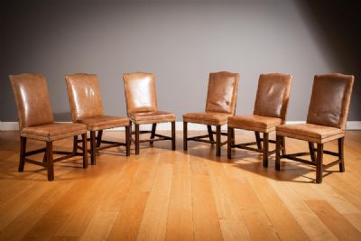 A SET OF SIX TANNED LEATHER UPHOLSTERED HUMPBACK DINING CHAIRS at deVeres Auctions