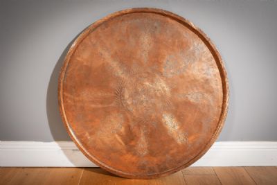 A LARGE COPPER CIRCULAR TRAY at deVeres Auctions