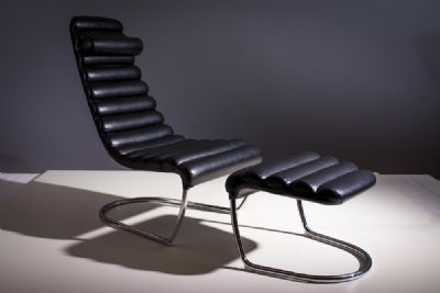 A BLACK LEATHER AND CHROME EASY CHAIR AND STOOL at deVeres Auctions