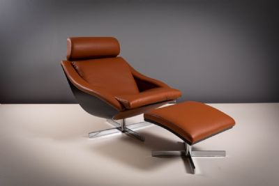 A TANNED LEATHER AND BEECH FRAMED 'BAKEA' SWIVEL ARMCHAIR AND FOOTSTOOL, by ROCHE BOBOIS  at deVeres Auctions
