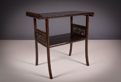 A HARDWOOD SCROLL TABLE at deVeres Auctions