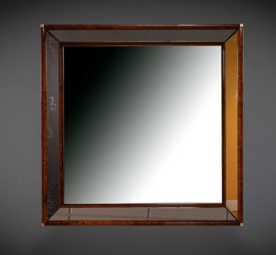 A WALNUT FRAMED WALL MIRROR at deVeres Auctions