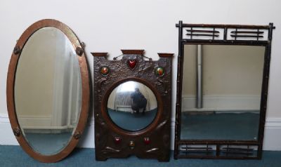 124 by A COPPER AND ENAMEL EMBOSSED ART NOUVEAU WALL MIRROR  at deVeres Auctions